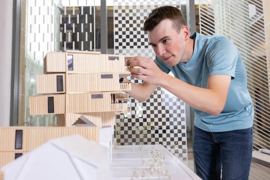 A person working on an Architectural model.